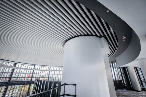 OWAtecta S19 linear metal baffles are suitable for commercial environments. Installed within a stairwell atrium